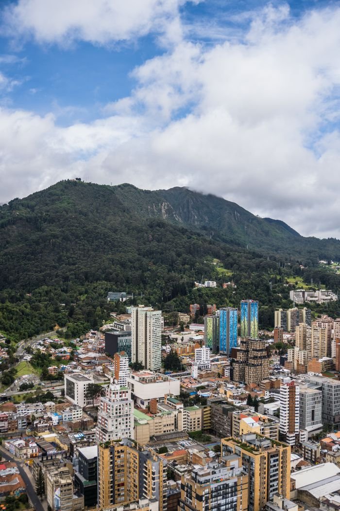 A stunning aerial view of Bogotá's urban landscape backed by the Andes Mountains in Colombia.