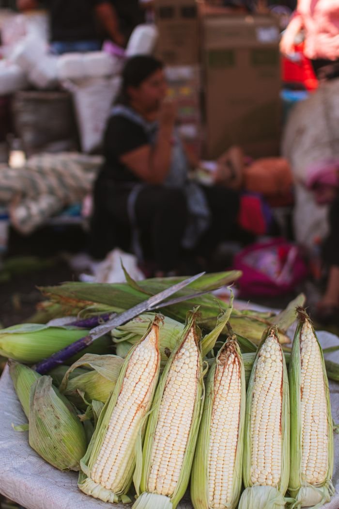 Mastering the First Impression: Your intriguing post title goes here Close-up of fresh corn on display at a bustling market in Ciudad de México, capturing the vibrant street scene.